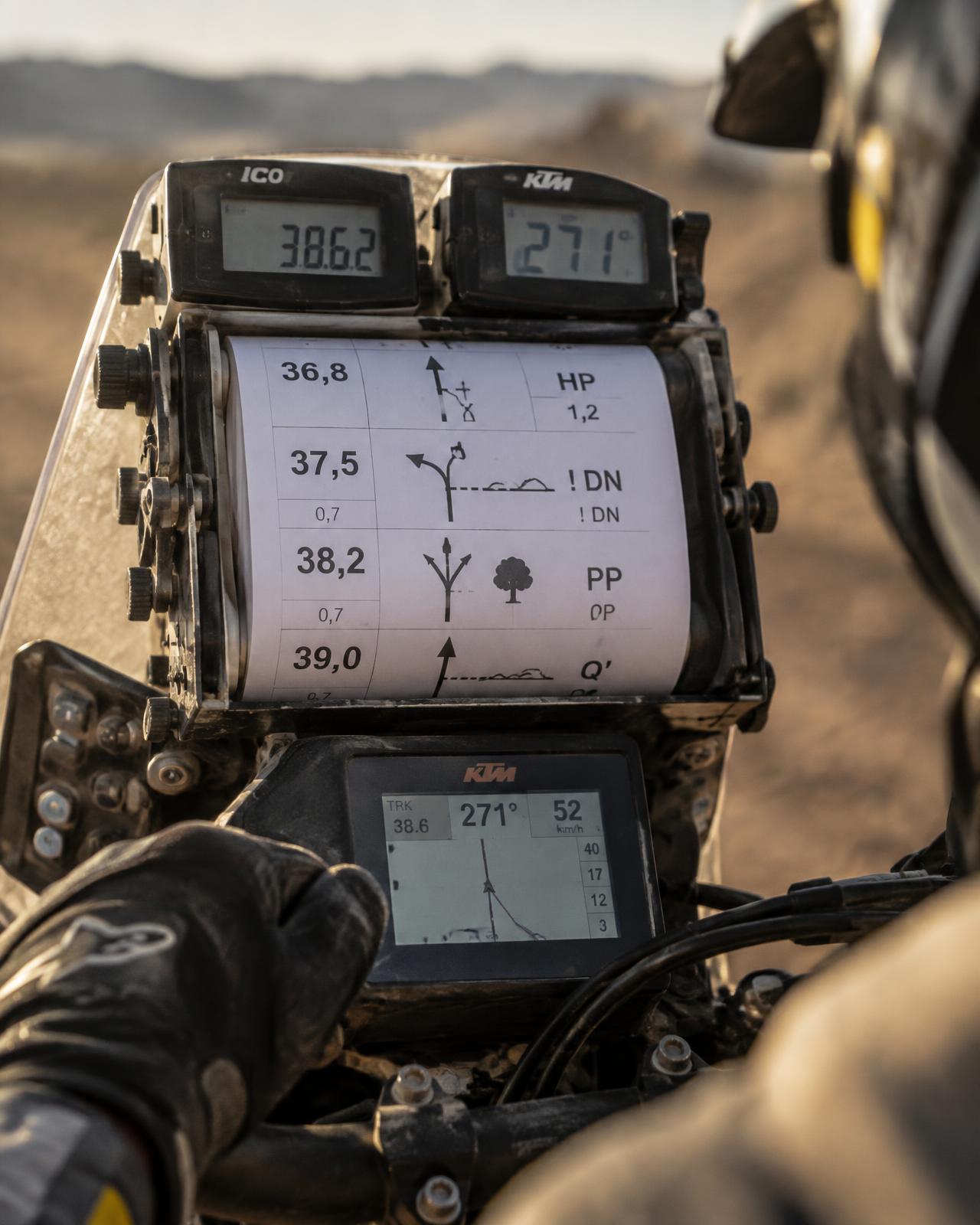 Roadbook scroll and tripmeter mounted on a rally motorcycle